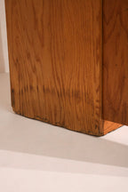 Close-up of oak wood grain and natural finish on the adjustable shelves of Mcm tall bookcase