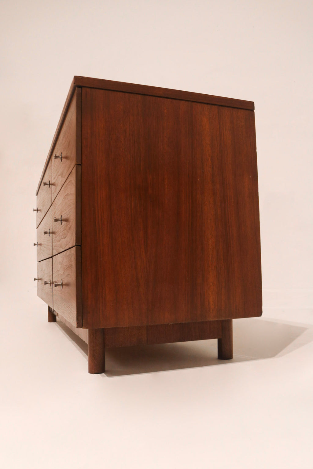 Side profile of dresser showing slim elegant lines and low height typical of mid-century modern style