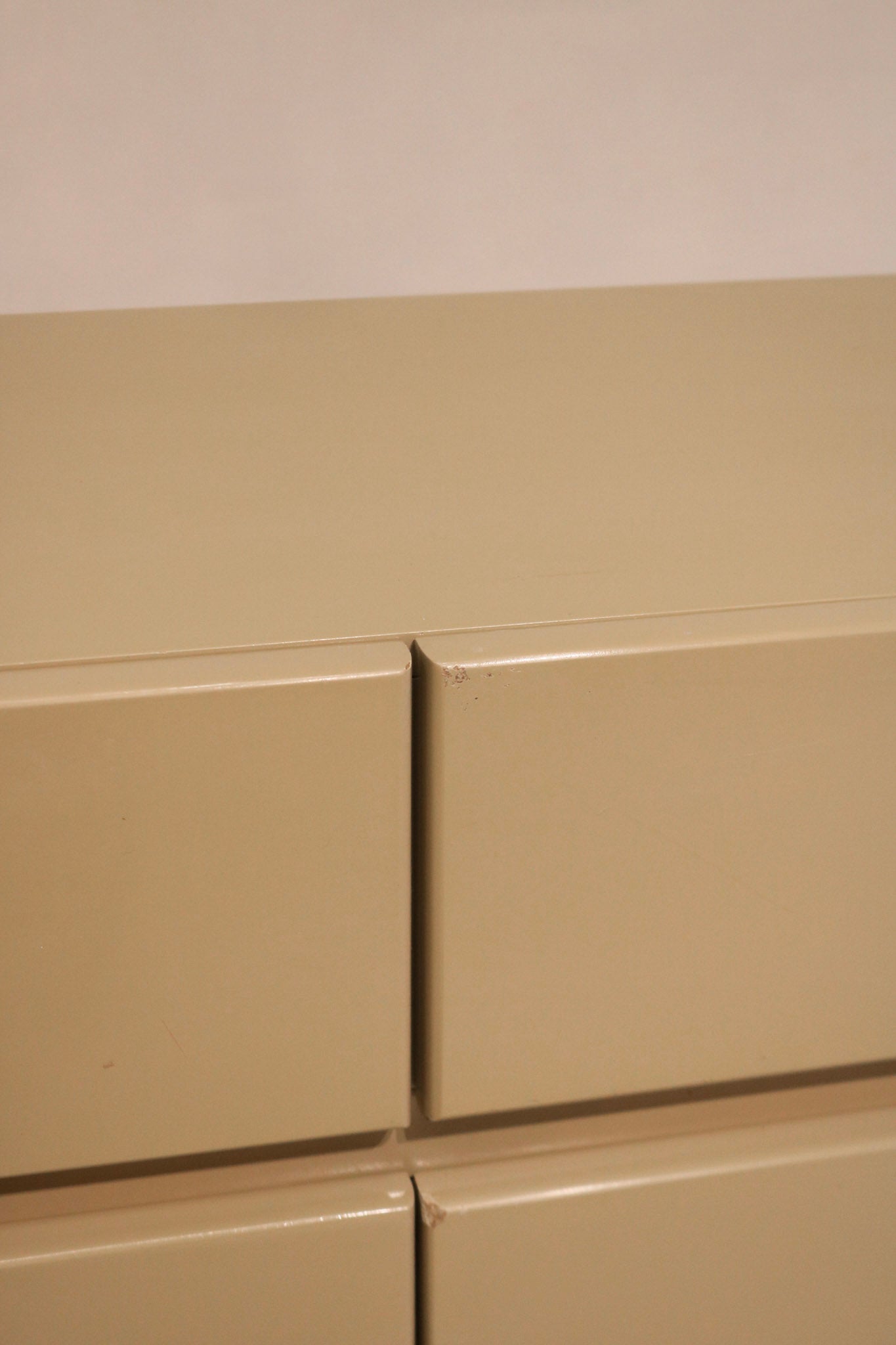 Zoomed view of middle drawers showcasing clean lines and vintage mid-century hardware