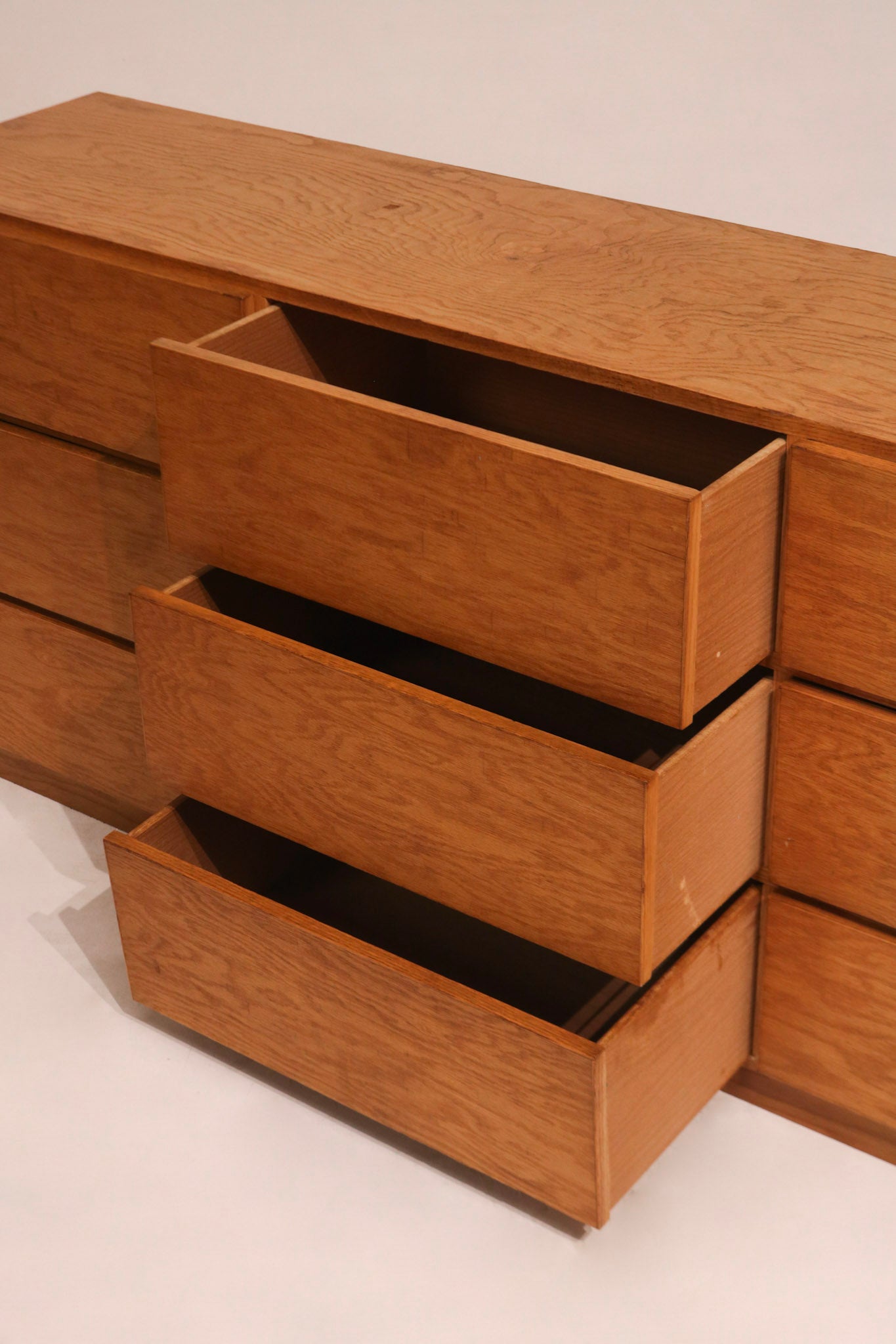 Angled side view emphasizing dresser legs and sturdy oak base construction