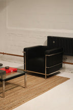 Detail view showing smooth black faux leather seat cushion and stitching finish