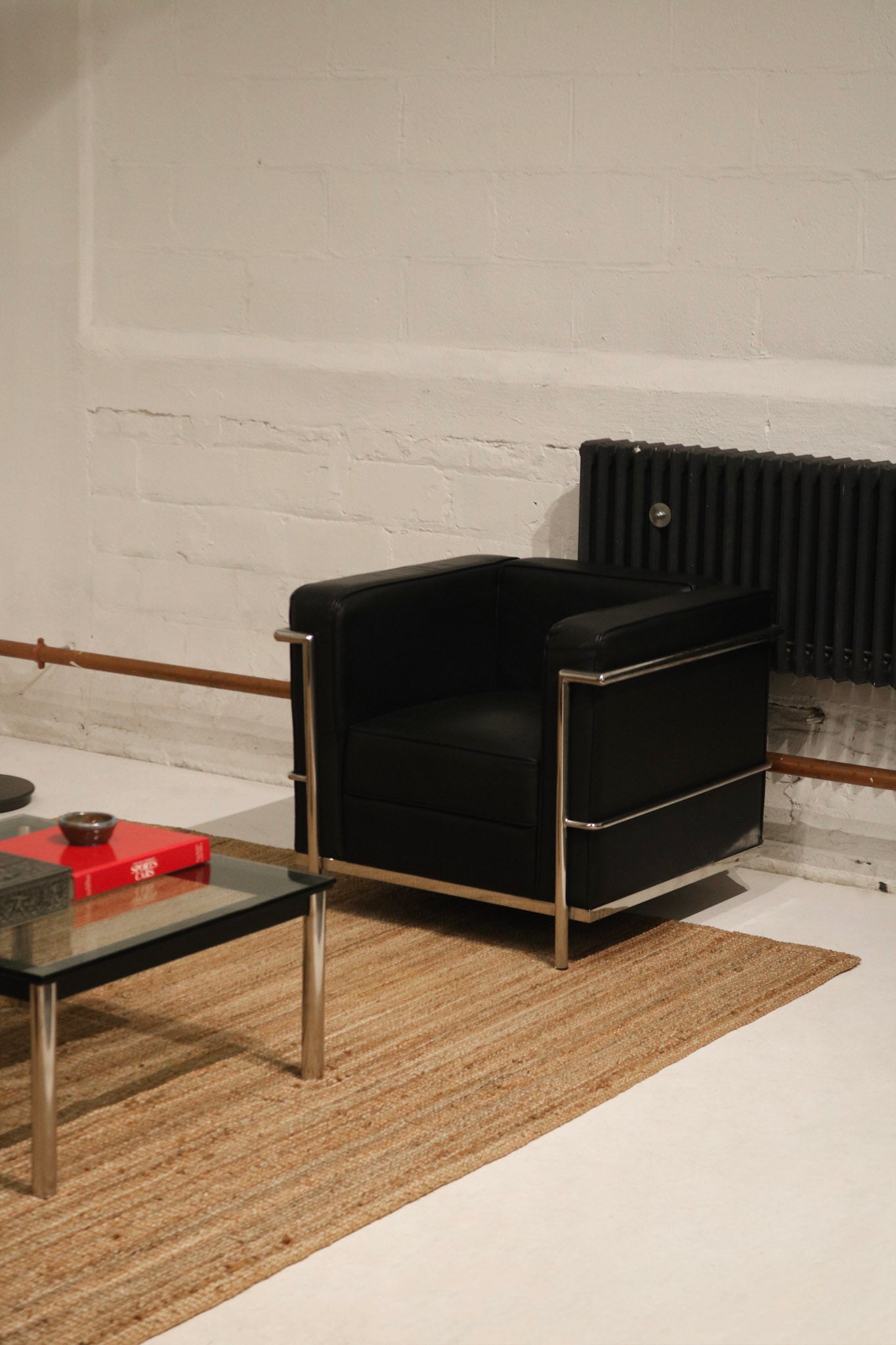 Detail view showing smooth black faux leather seat cushion and stitching finish