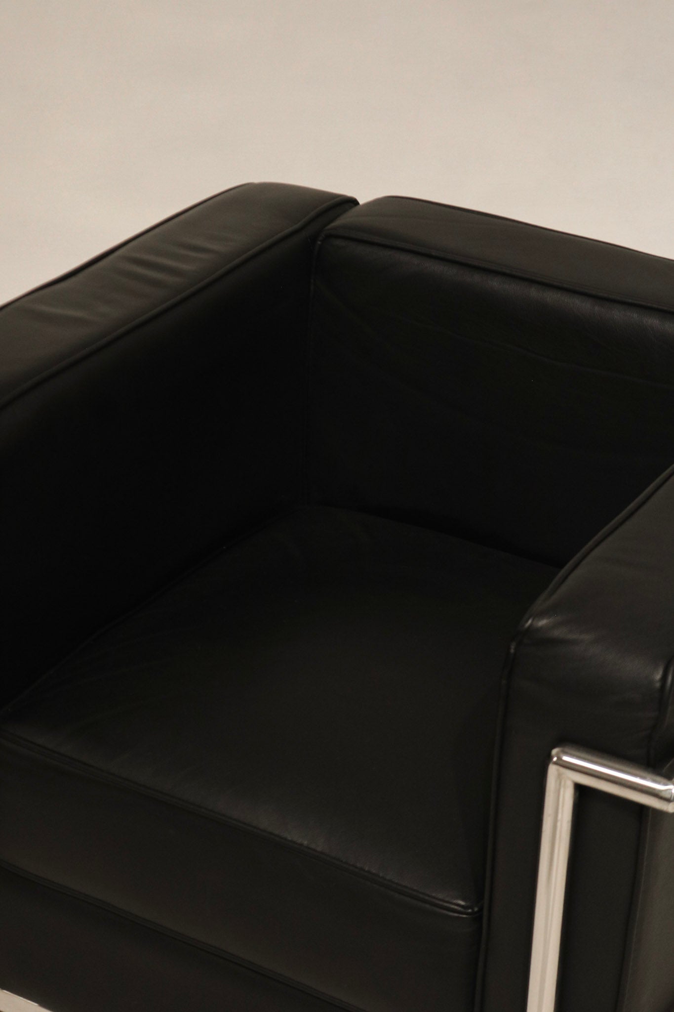 Texture detail of black faux leather upholstery, high-quality and like-new