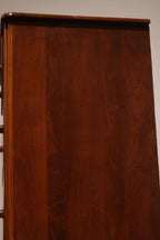 Macro close-up of maple wood grain and lacquered finish on dresser exterior