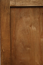 Close-up of carved edge profile and grain pattern in pine wood panels, highlighting hand-finished surface and light wear.