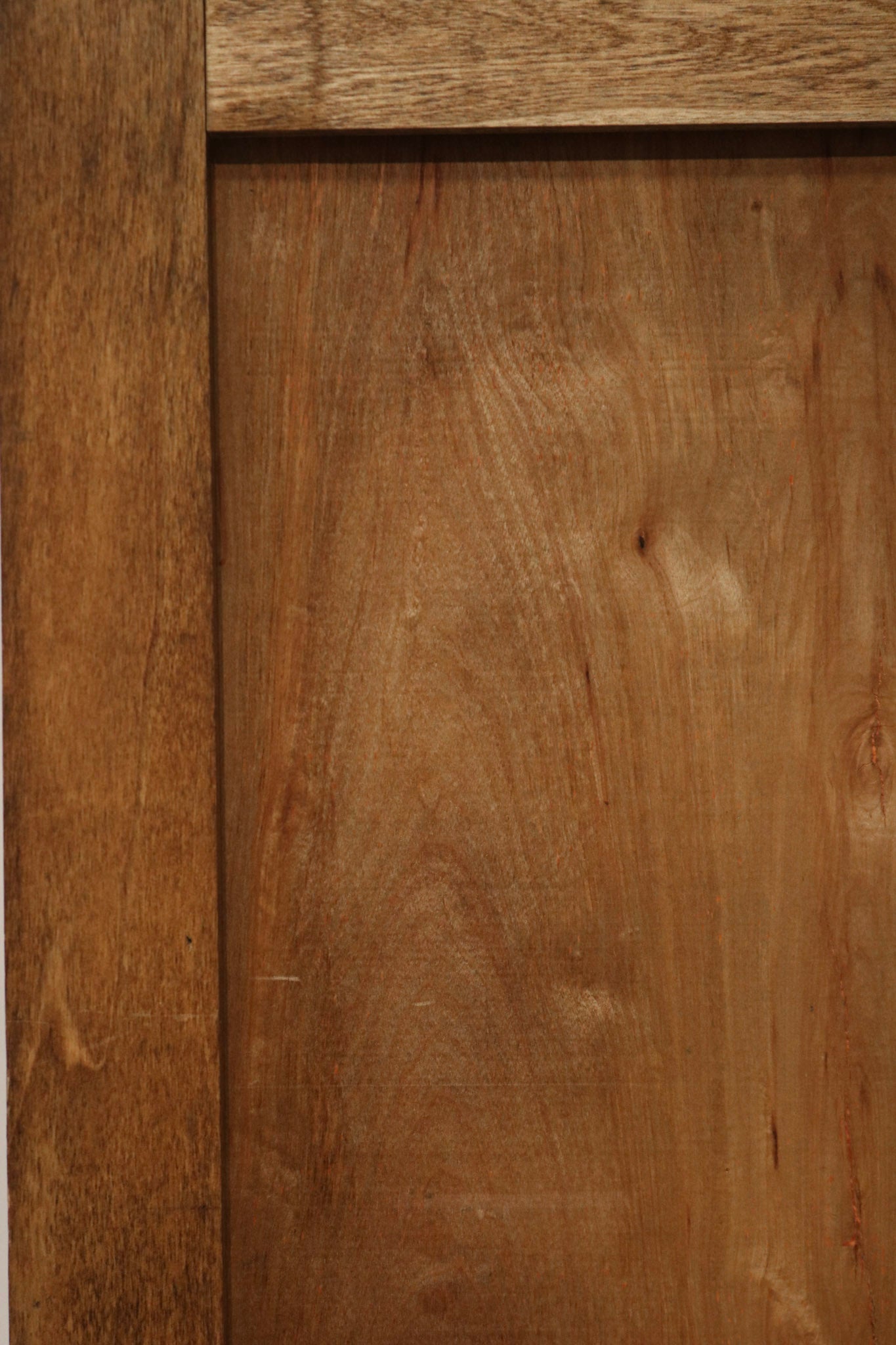 Close-up of carved edge profile and grain pattern in pine wood panels, highlighting hand-finished surface and light wear.