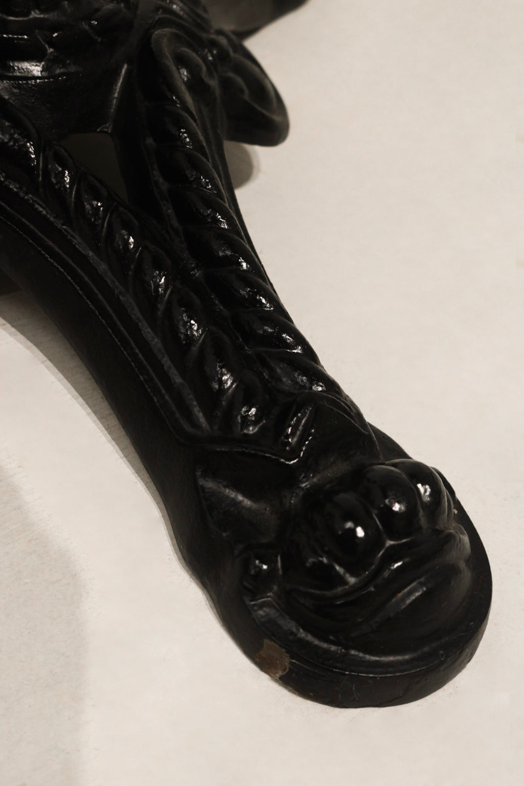 Detailed view of iron base construction on Vintage Bistro Table showcasing vintage black finish and sturdy legs