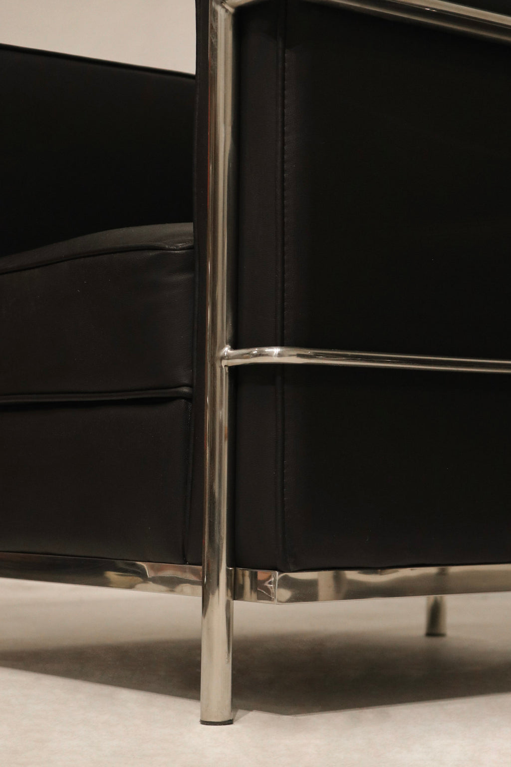 Underside view showing chrome legs and frame of LC2 armchairs, modern polished finish
