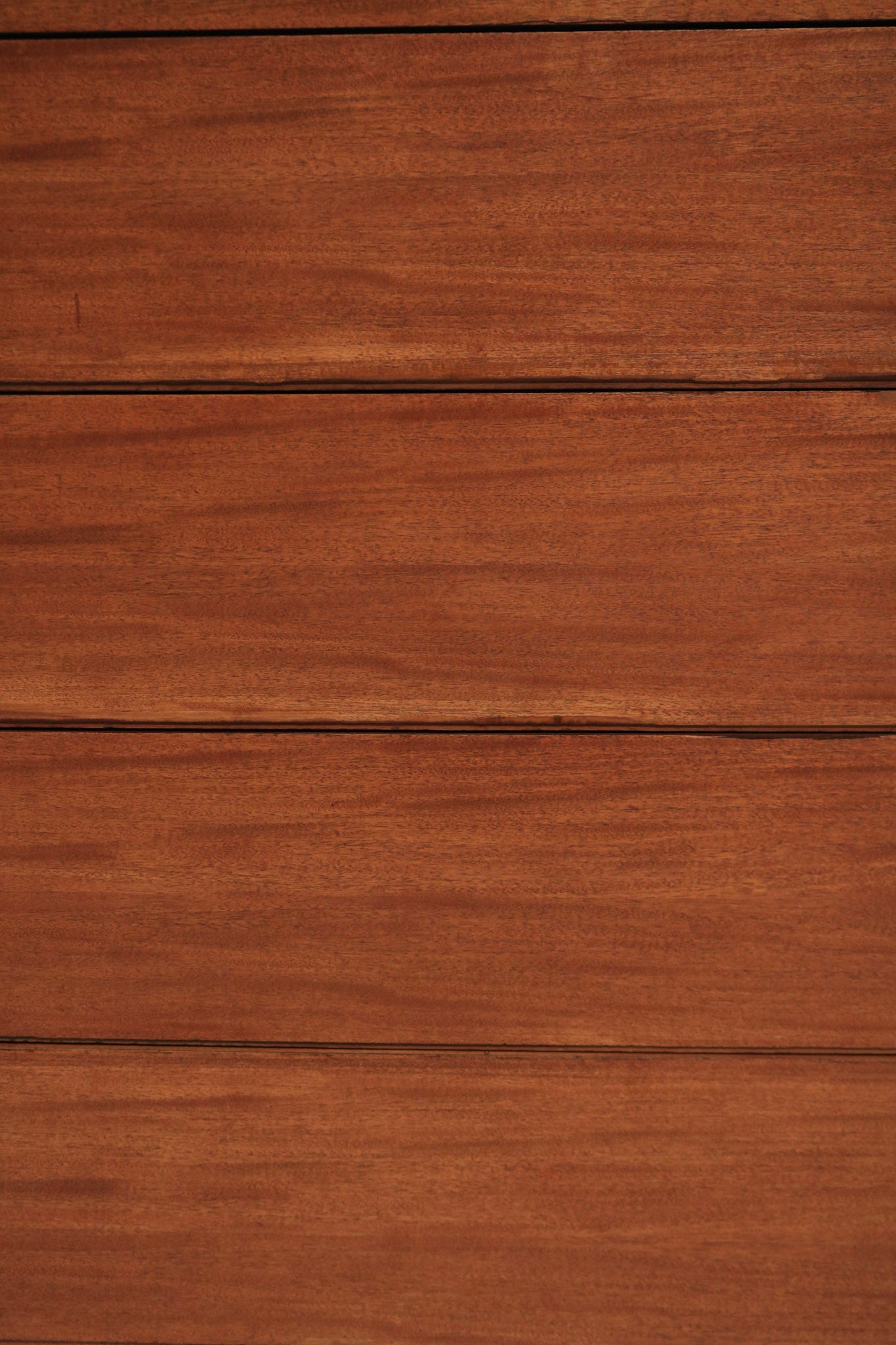 Detail photo of corner and leg junction on solid wood dresser chest, heavy sturdy support and sanded stained walnut finish visible