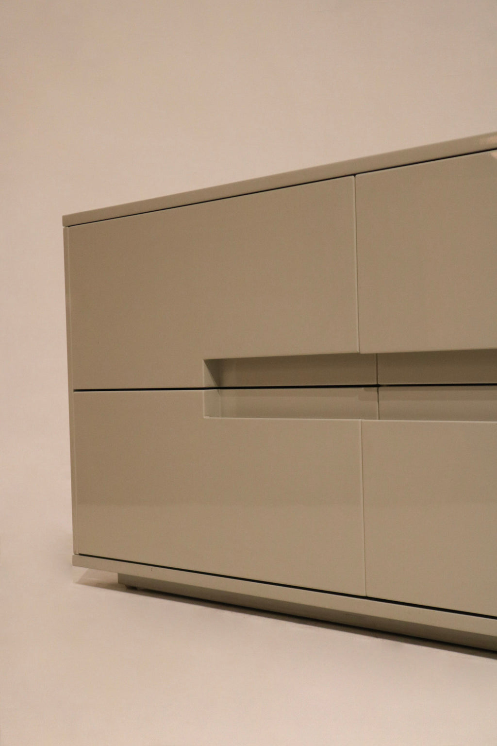 Zoom-in on corner chip of dresser, highlighting minor wear on lacquered wood