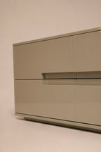 Zoom-in on corner chip of dresser, highlighting minor wear on lacquered wood