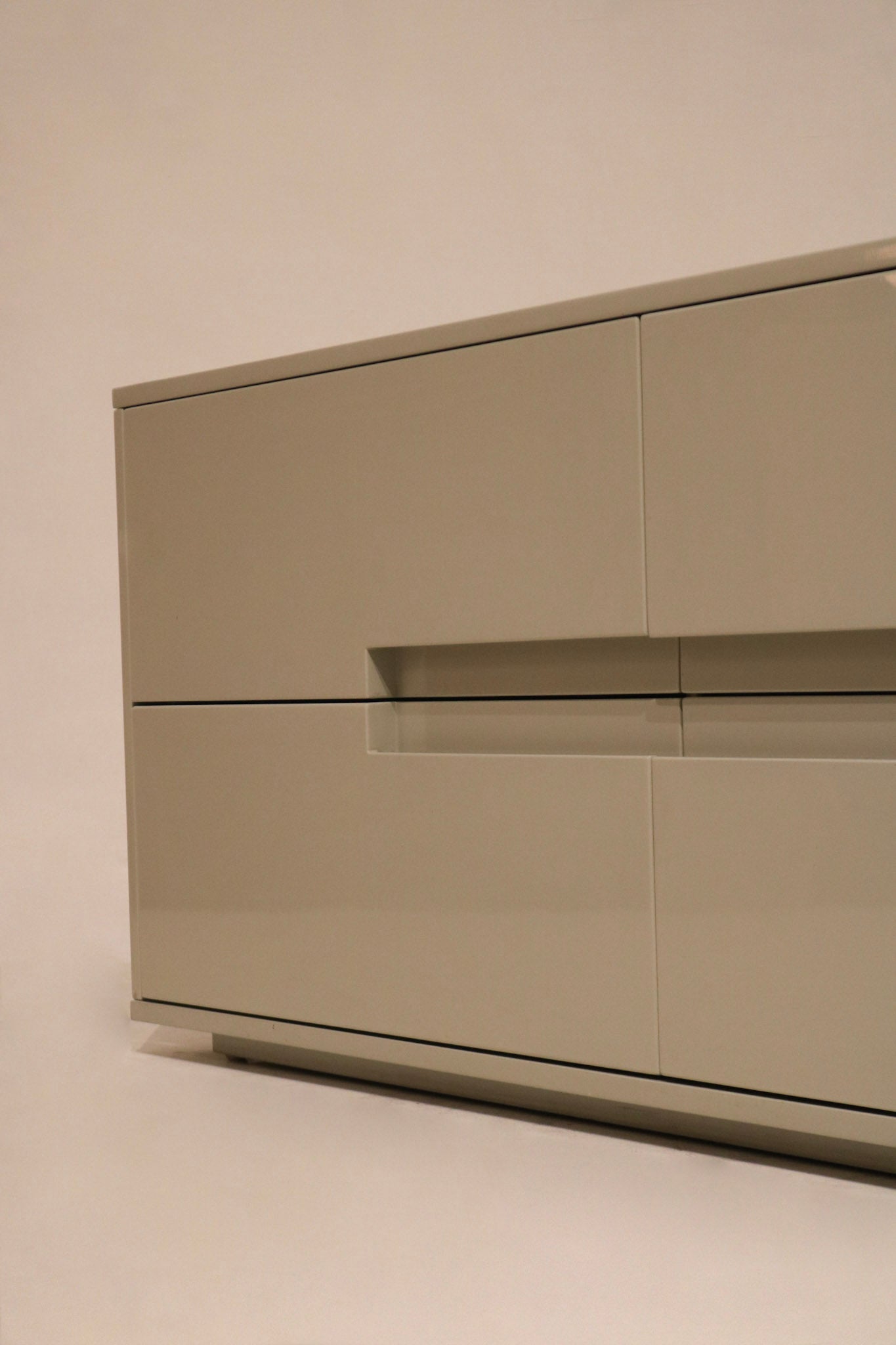 Zoom-in on corner chip of dresser, highlighting minor wear on lacquered wood