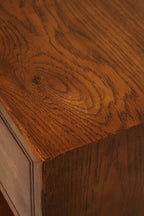 Detail of drawer front and brass knob on Vintage Mcm Oak Nightstand, highlighting solid wood construction