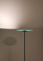 Detailed view of the lamp's chrome hardware and base, highlighting reflective metal against glass construction