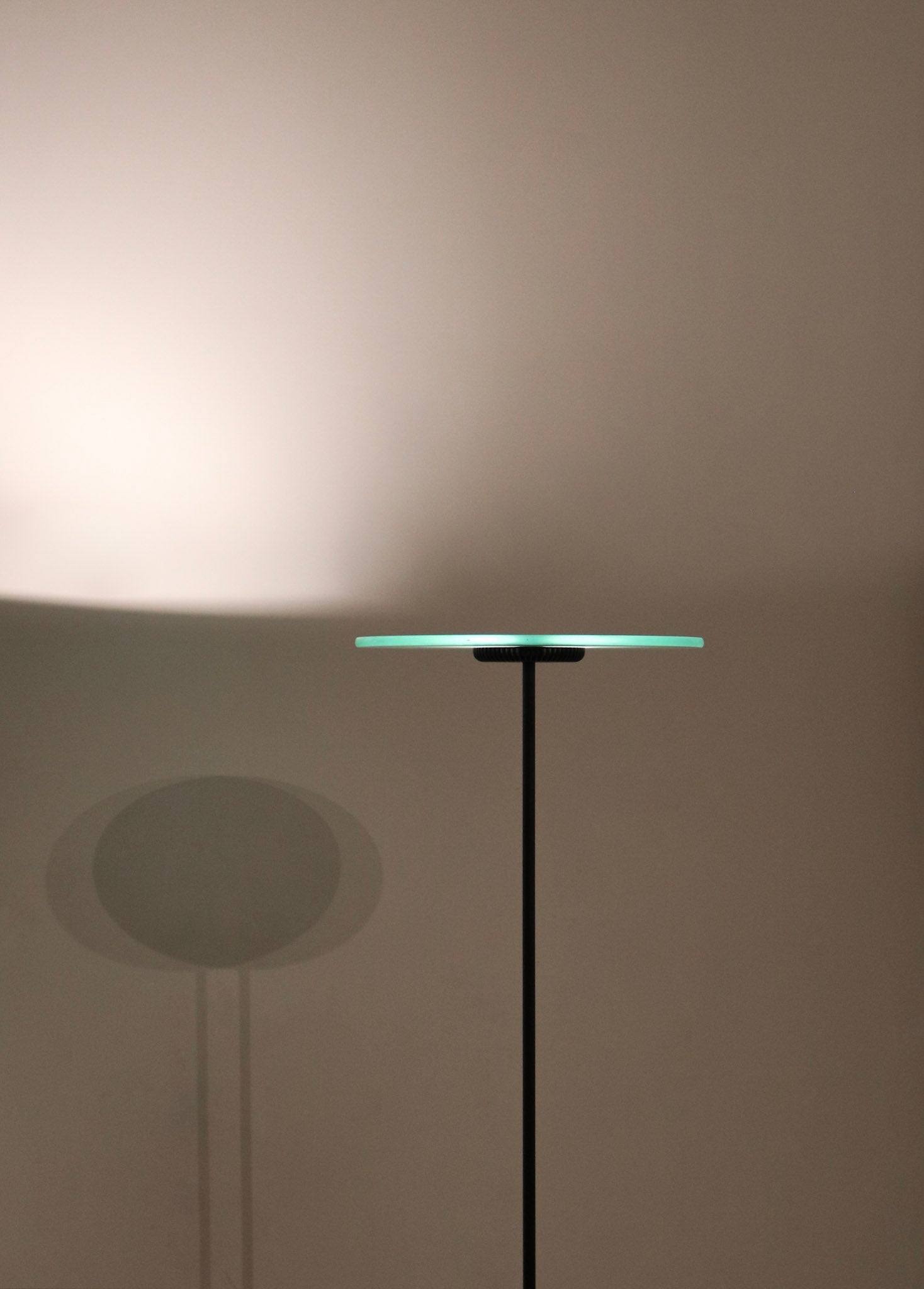 Detailed view of the lamp's chrome hardware and base, highlighting reflective metal against glass construction