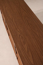 Angled side view of Johnson Carper dresser showing all 9 drawers and rich walnut wood tones