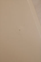 Top-down image of nightstand surface finish displaying white lacquer color and sheen