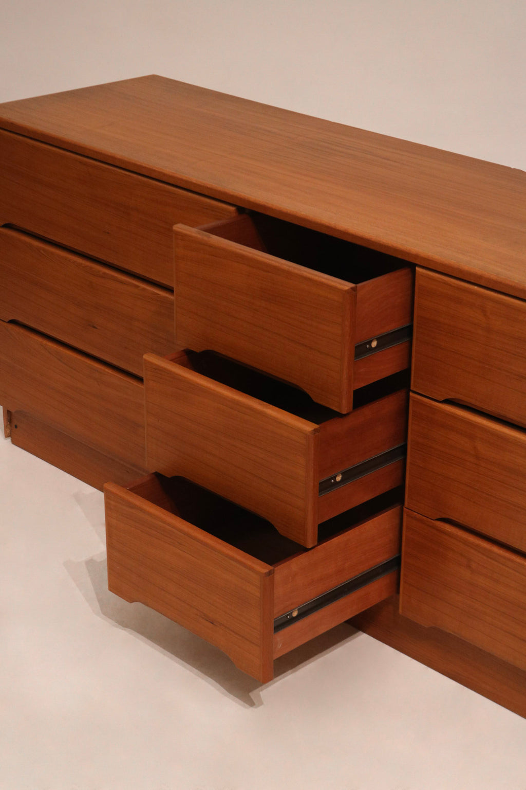 Underside of the dresser showing leg joints and base support in solid teak wood