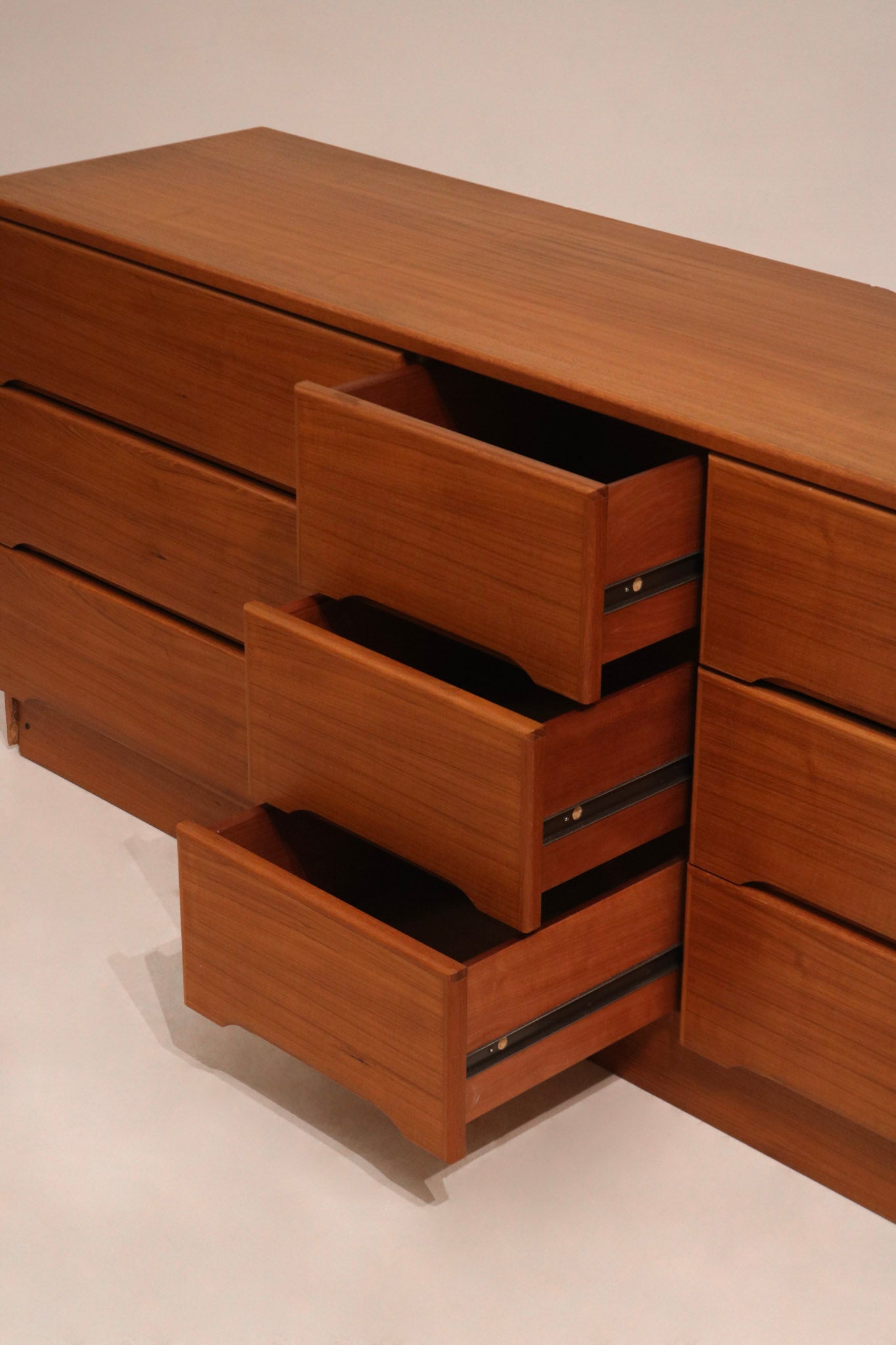 Underside of the dresser showing leg joints and base support in solid teak wood