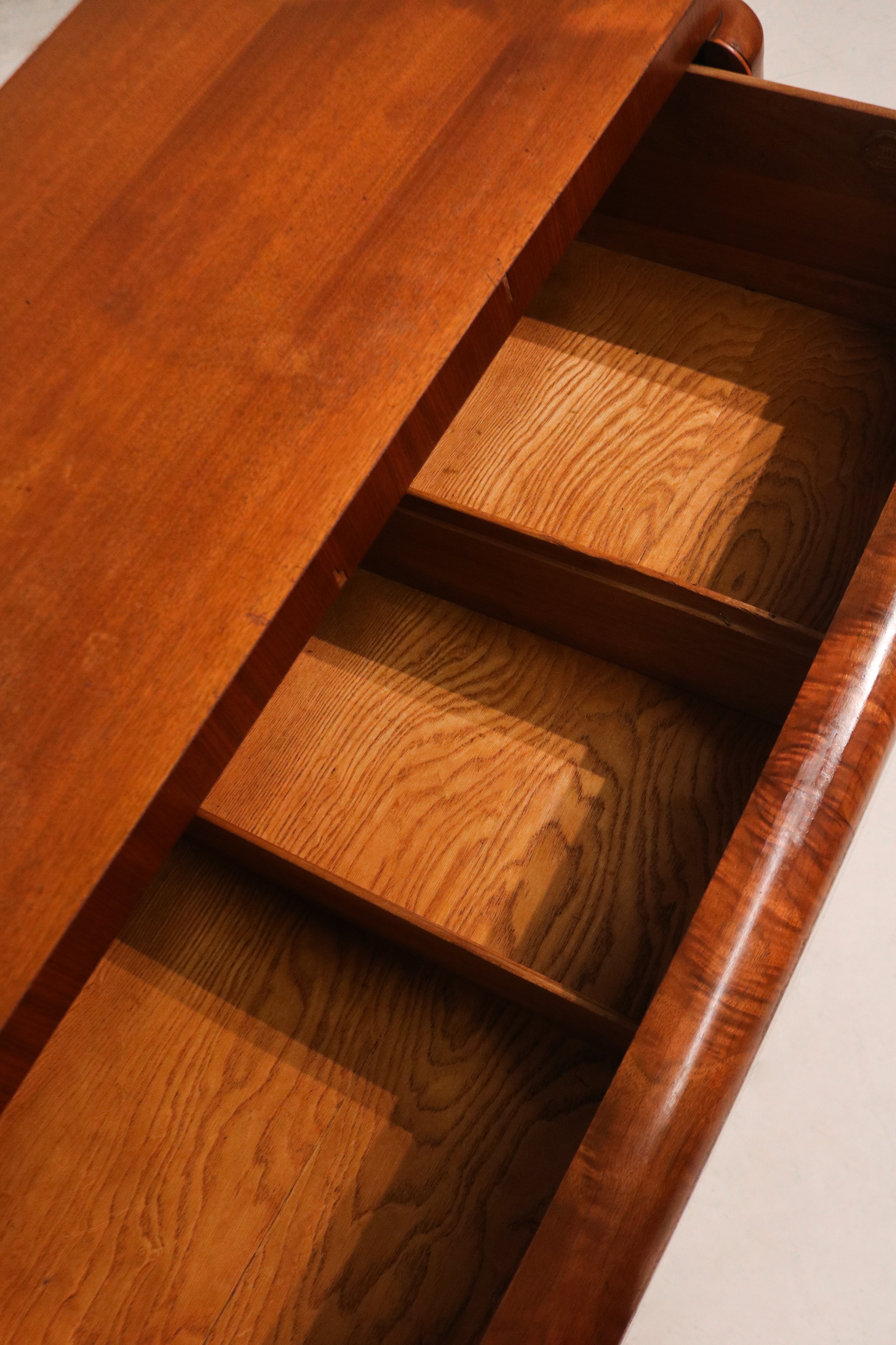 Close-up of keyhole detail on center drawer with vintage Art Deco design elements