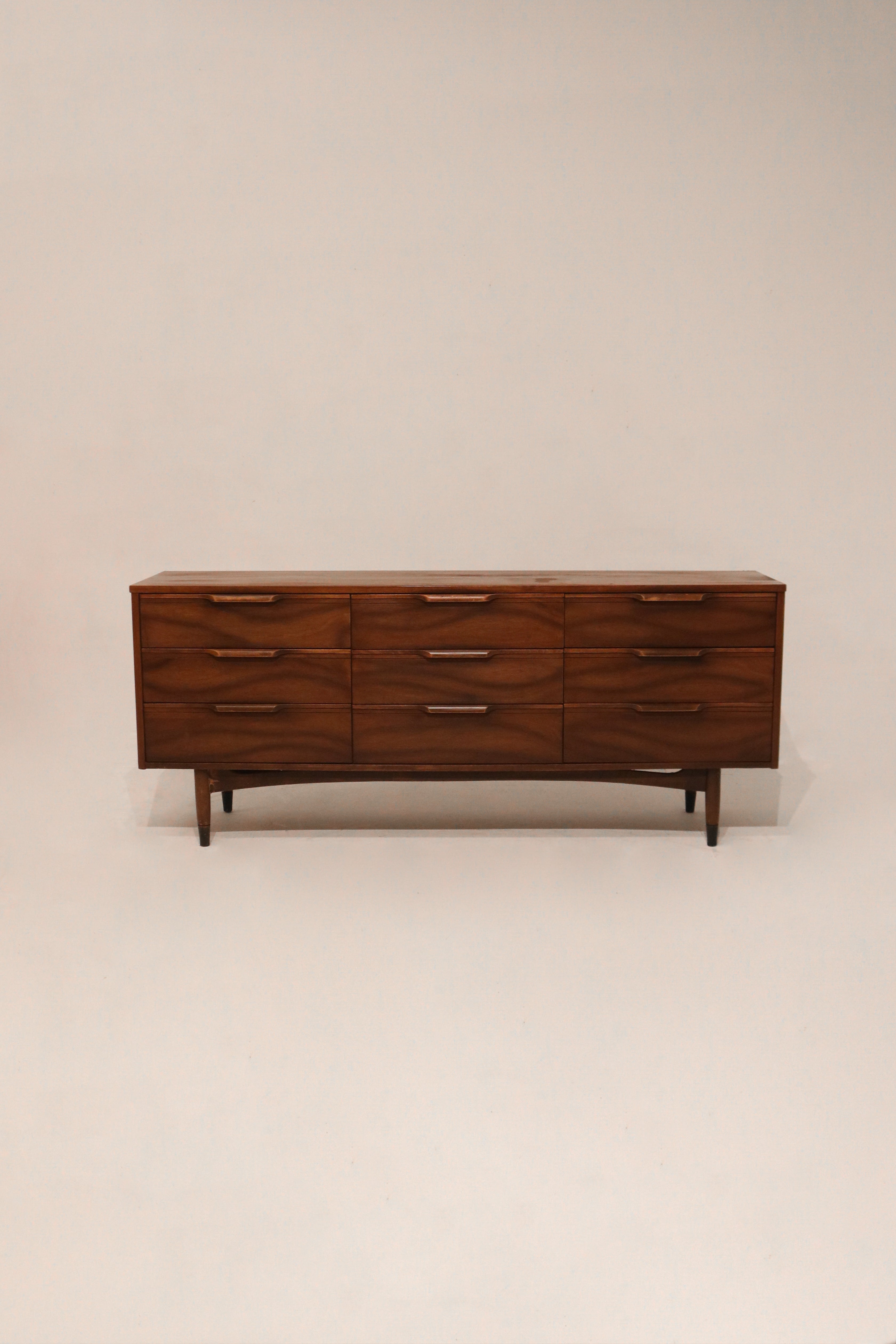 Main view of Mid Century Modern dresser with walnut wood finish and 9 drawers in full frame