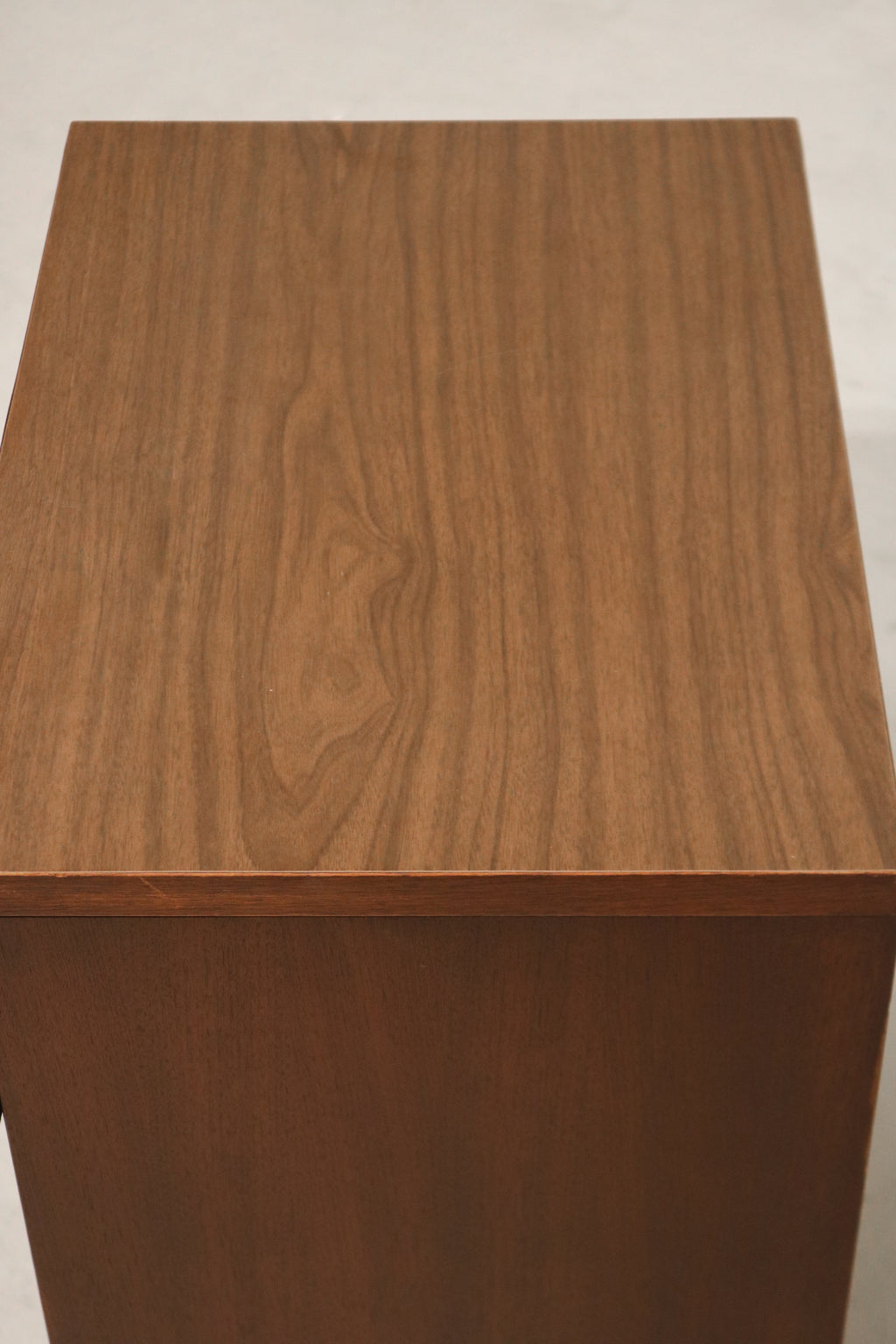 Side view showing profile of walnut body and elegant craftsmanship
