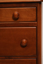 Angle shot of highboy dresser corner showing wood grain and finish quality