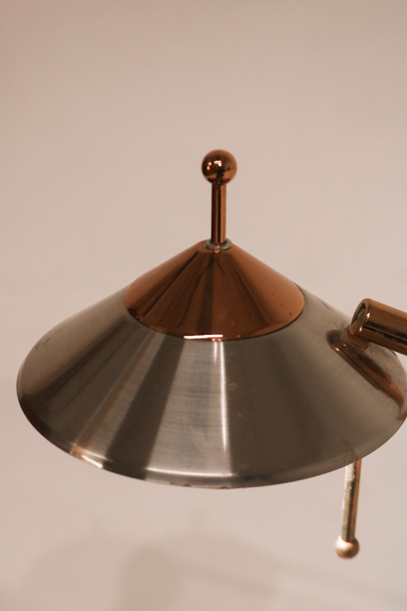 Angled view of chrome adjustable desk lamp showing articulating arm and vintage aesthetics