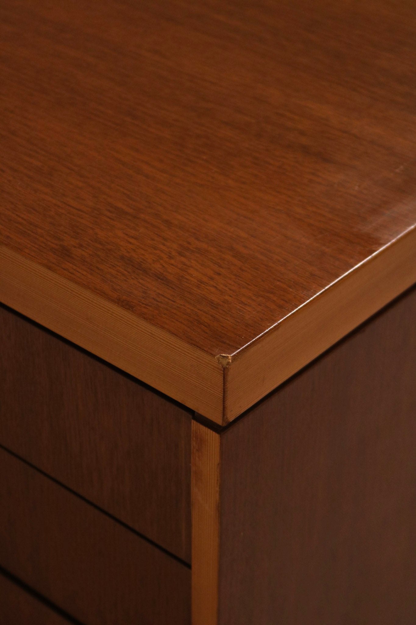 Angled view capturing depth and profile of the credenza's body and metal base