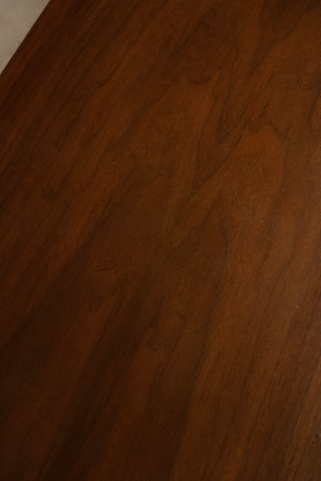 Detail of drawer fronts showing walnut grain continuity, original hardware and precise solid wood joinery