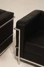 Front-facing shot of both LC2 chairs, perfect pair for stylish NYC living room