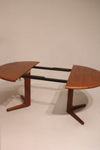 Side angle showing proportional legs and rounded corners of teak dining table
