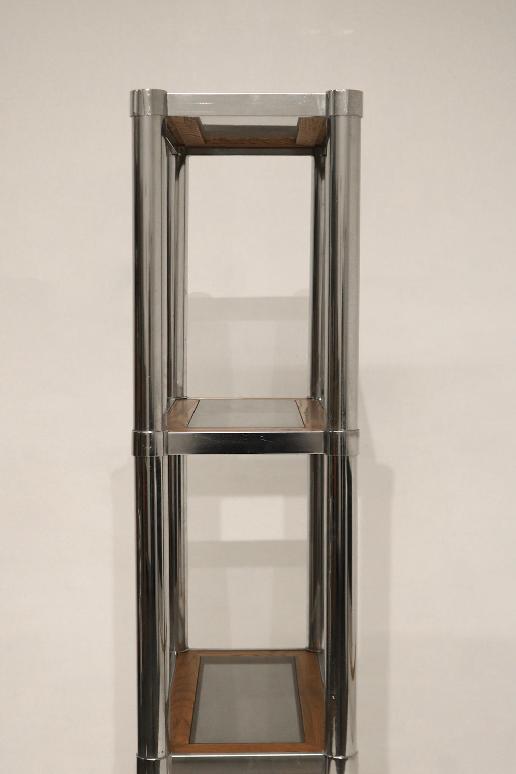 Detail of wood shelf showing rich grain and smooth surface on Vintage Chrome Glass Wood Bookcase