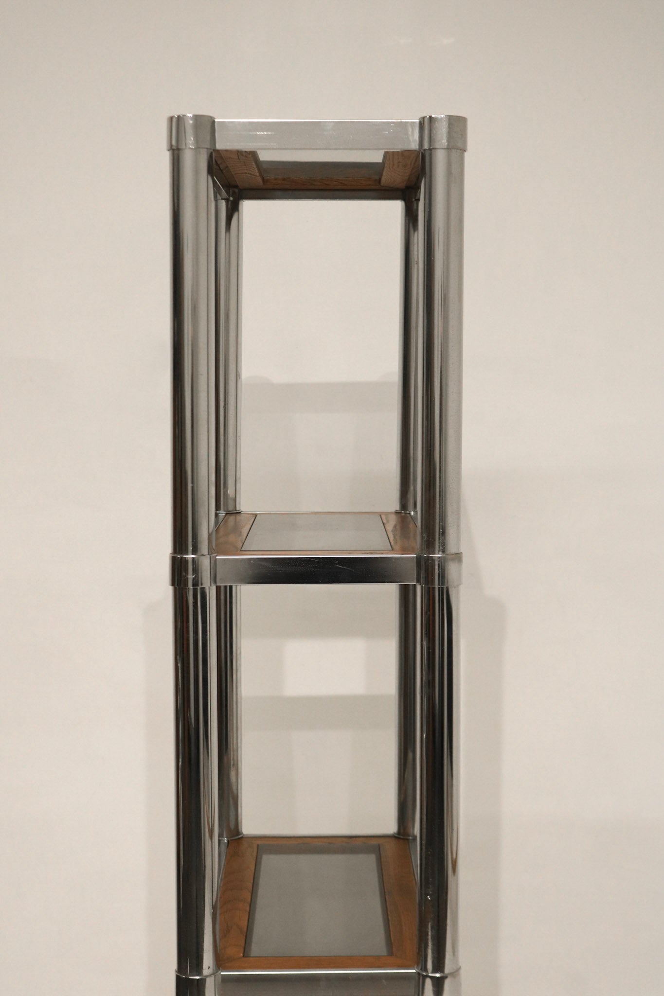 Detail of wood shelf showing rich grain and smooth surface on Vintage Chrome Glass Wood Bookcase