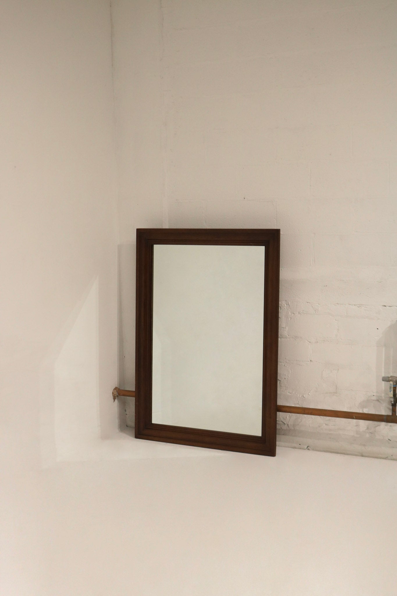 Main view of Large Vintage Mcm solid wood frame mirror, 51 x 37 inches, walnut wood grain, full reflective surface with light scratches visible