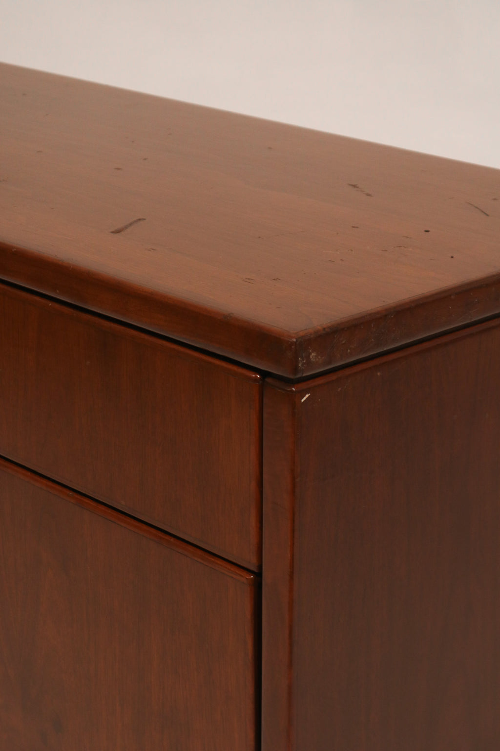 Close-up of wood grain texture on top surface showing minor wear marks in hardwood