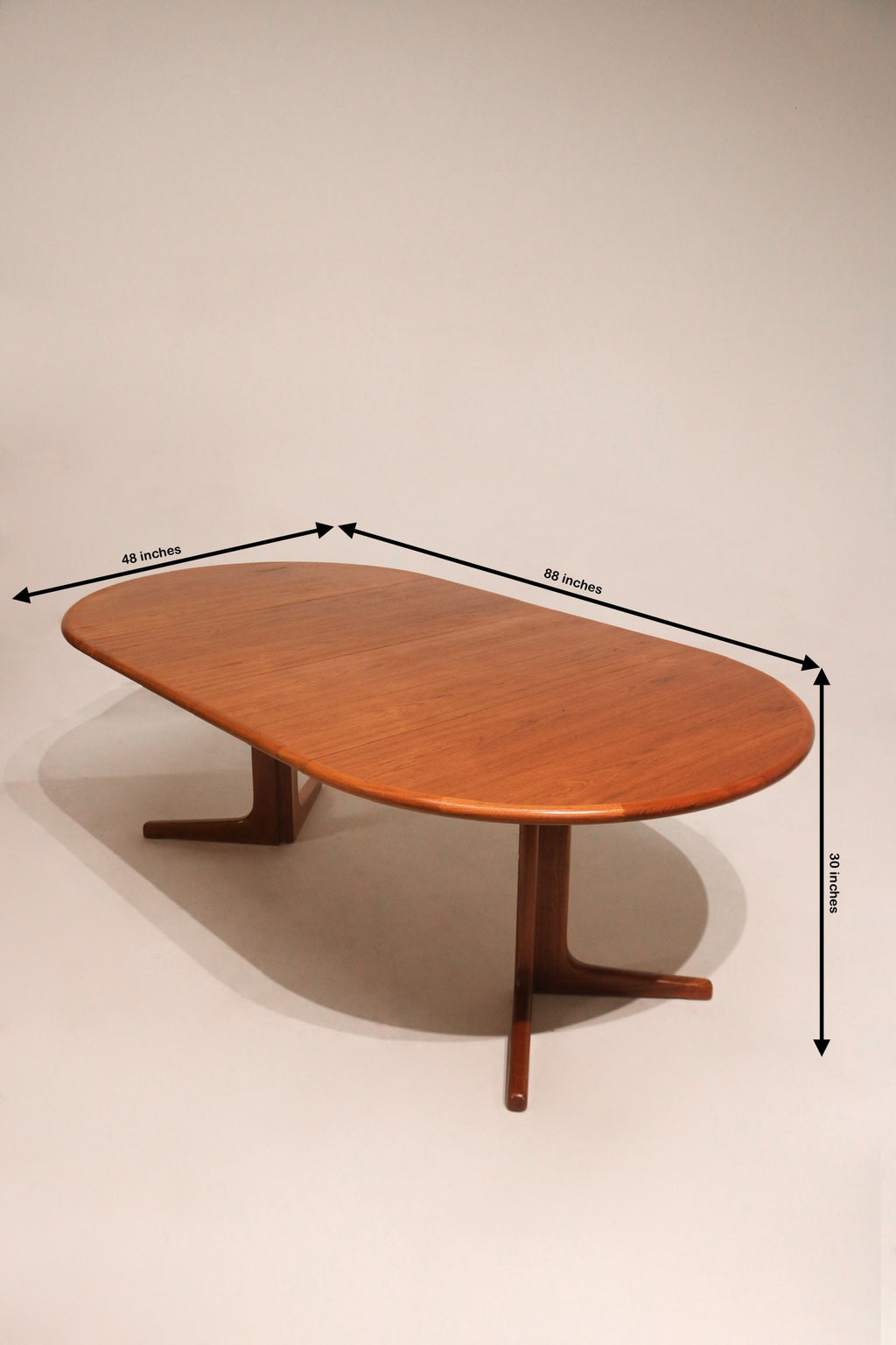 Measured dimensions of extendable teak dining table shown with length and height in inches