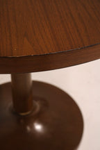 Side profile of round bistro table revealing leg structure and compact size