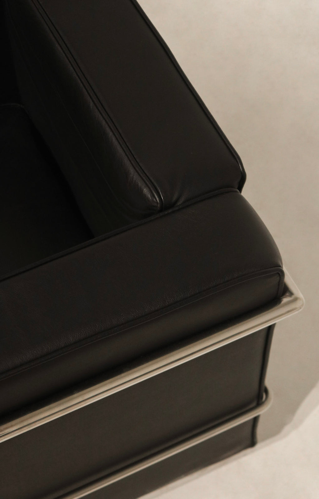 Top-down perspective of cushion layout on black faux leather armchair