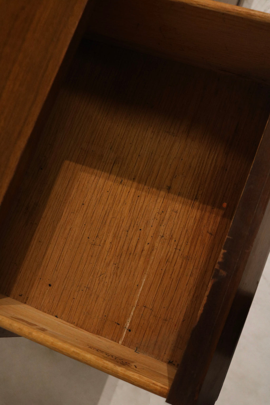 Mid-century profile detail focusing on clean horizontal lines, low silhouette and refined walnut finish