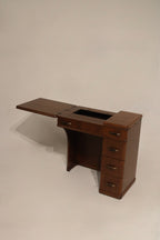 Detail: right leaf extended view of walnut wood side table with smaller leaf open, showing seam and hardware alignment