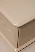 Close-up of side panel showing vintage white lacquer over natural wood grain