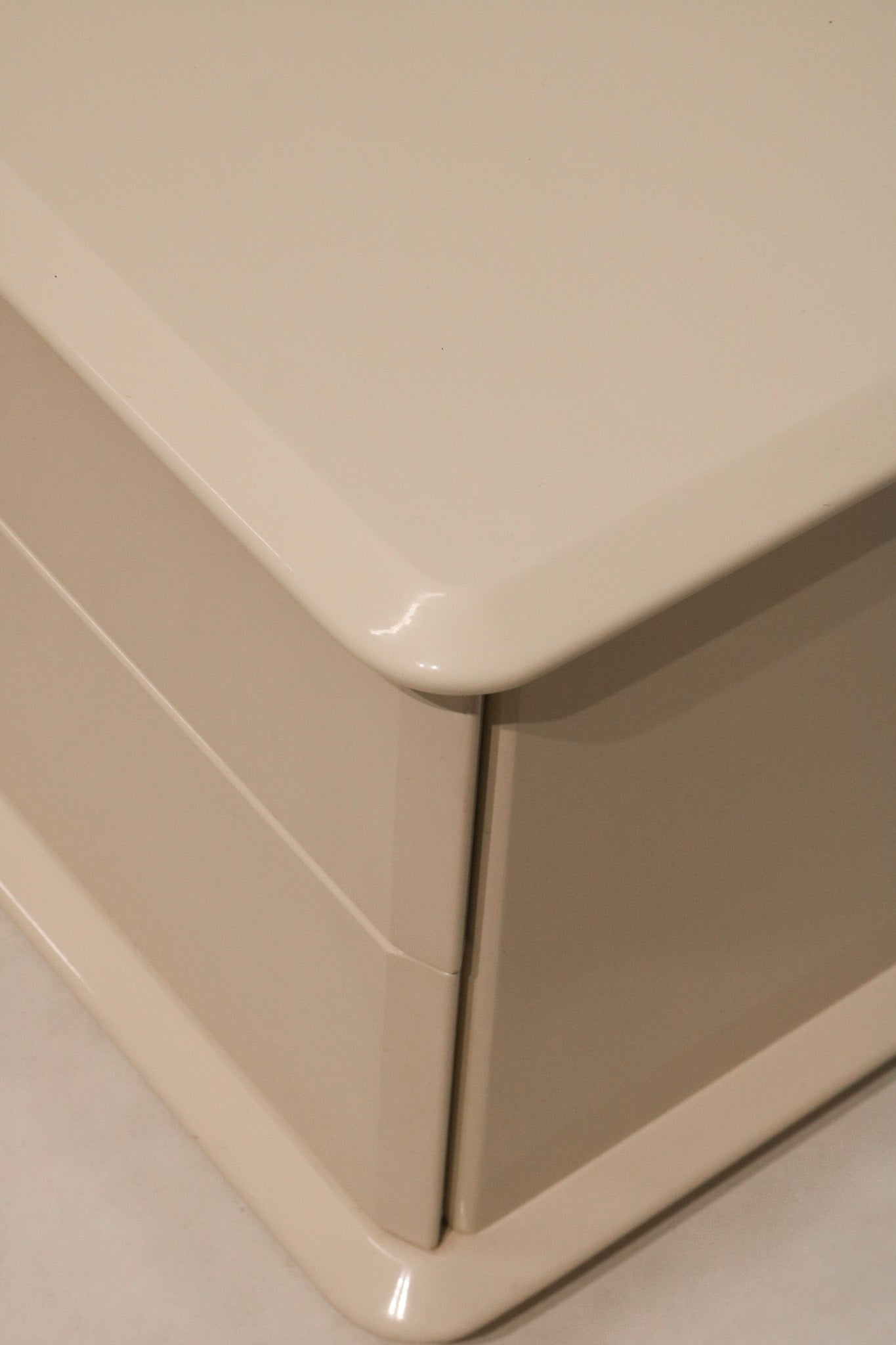 Close-up of side panel showing vintage white lacquer over natural wood grain