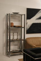 Close-up of chrome frame on vintage bookcase showing minor wear and polished finish