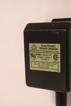 Detail of adjustable steel arm showcasing chrome joints and hardware construction