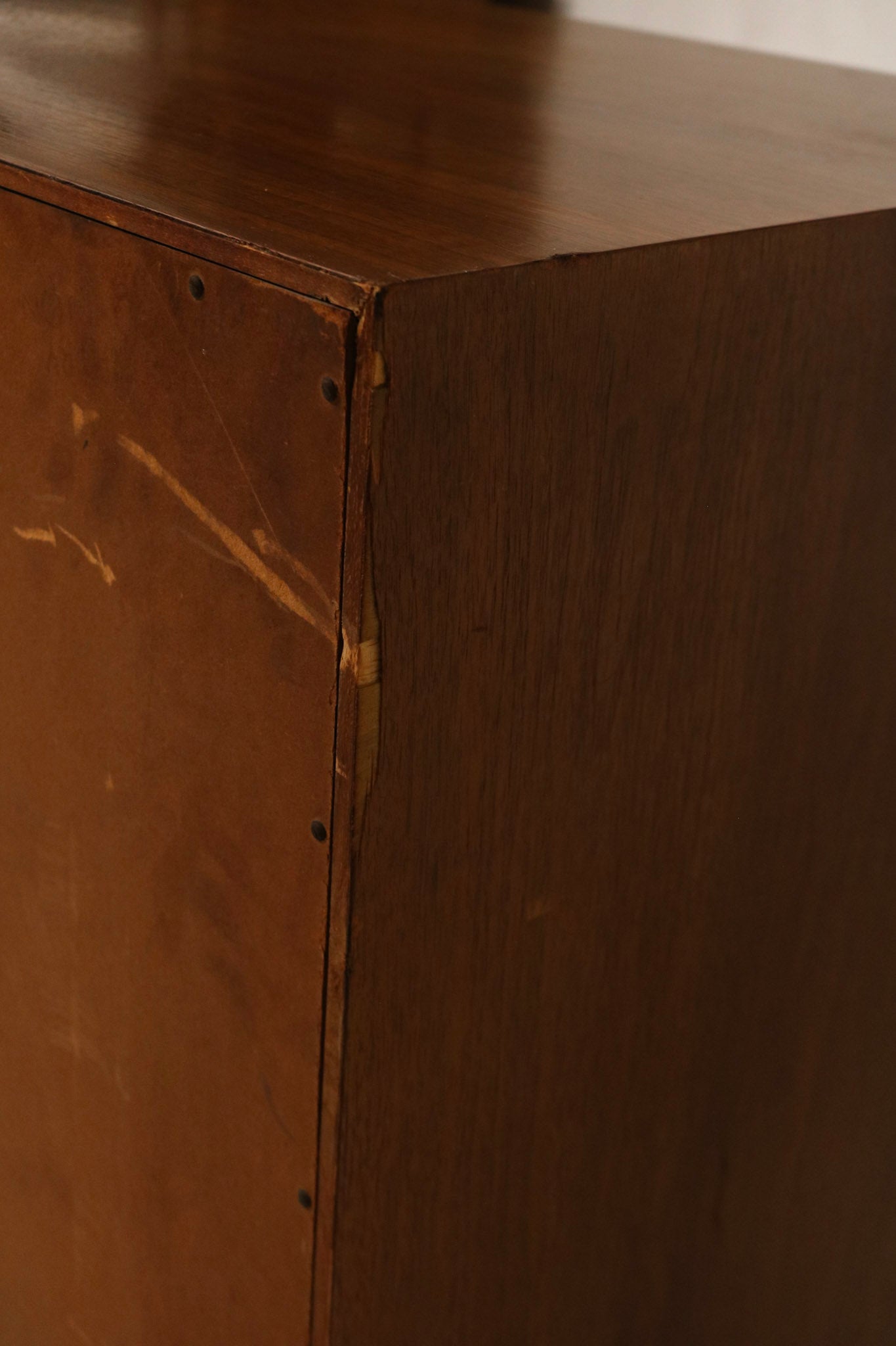Close-up of walnut grain on dresser top showing solid wood texture, warm tones and smooth mid-century finish