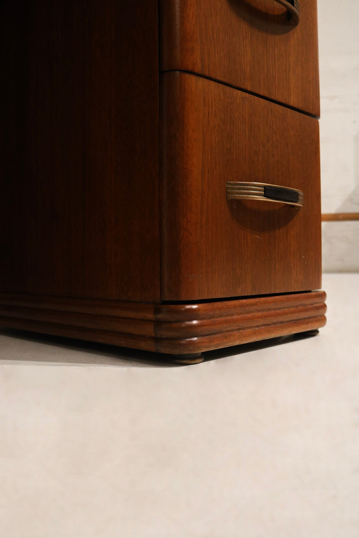Detail: close-up of walnut wood leg and foot showing tapered profile, joinery marks and original finish wear