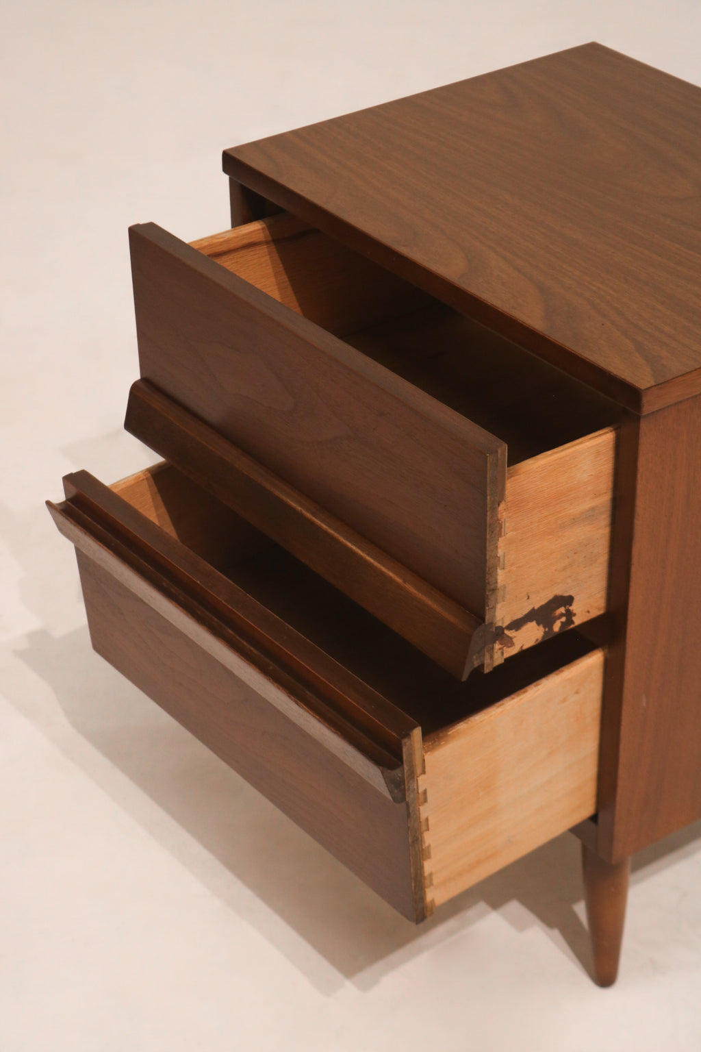 Interior view of open drawer showing clean wood lining and storage space