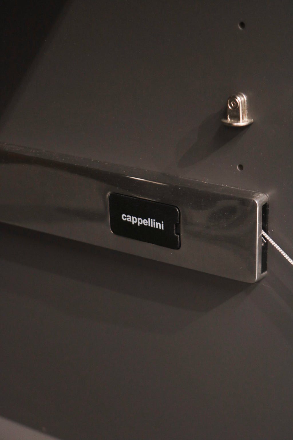 Top surface detail of lacquered wood texture with reflective finish on storage cabinet