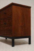 Close-up of walnut wood grain texture on cabinet surface with natural finish